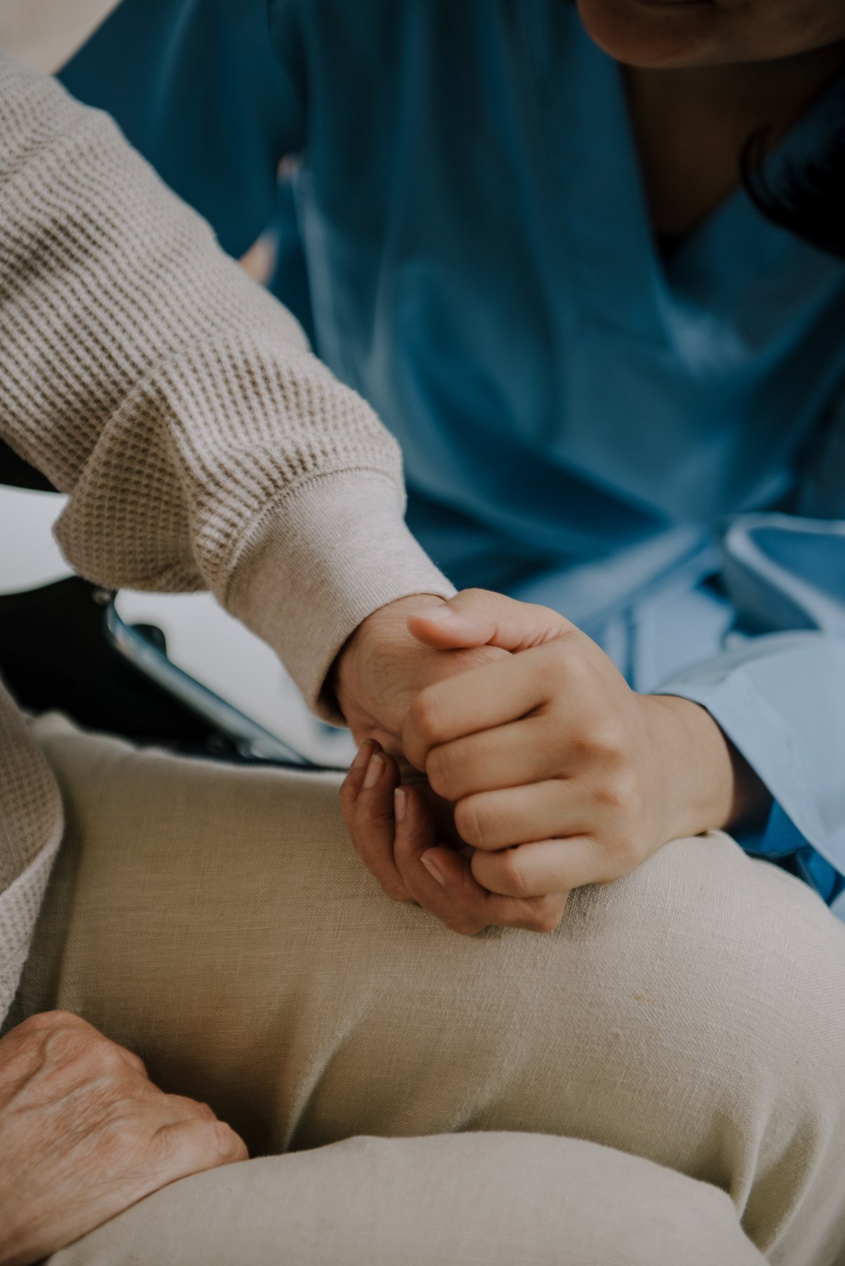 Nurse Holding the Hand of an Elderly Woman